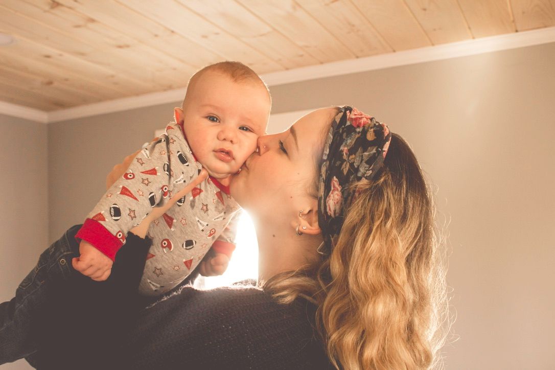 Intimate indoor family lifestyle photography session with natural lighting.