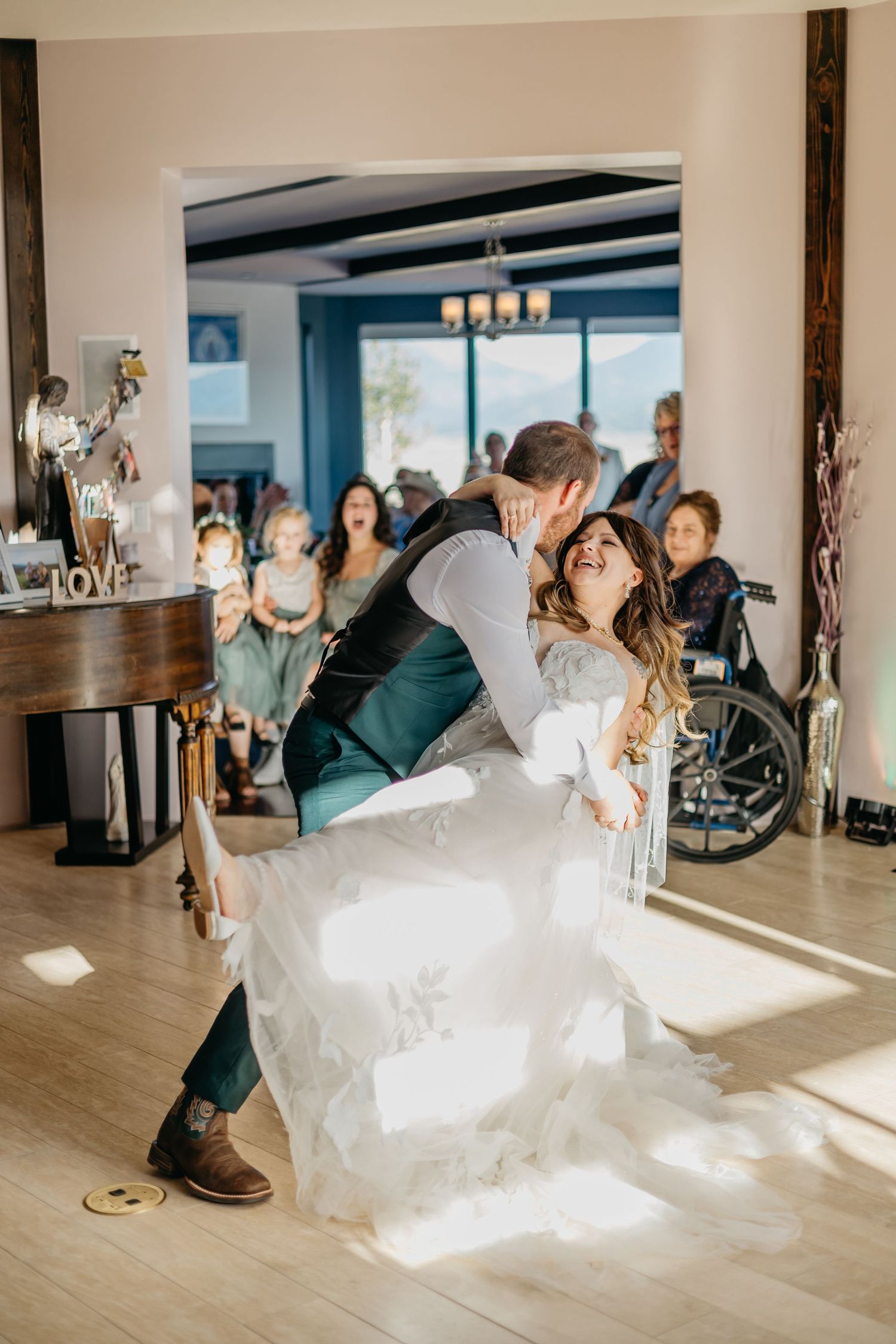 Dancing couple spins across a sunlit hardwood floor during their wedding celebration.