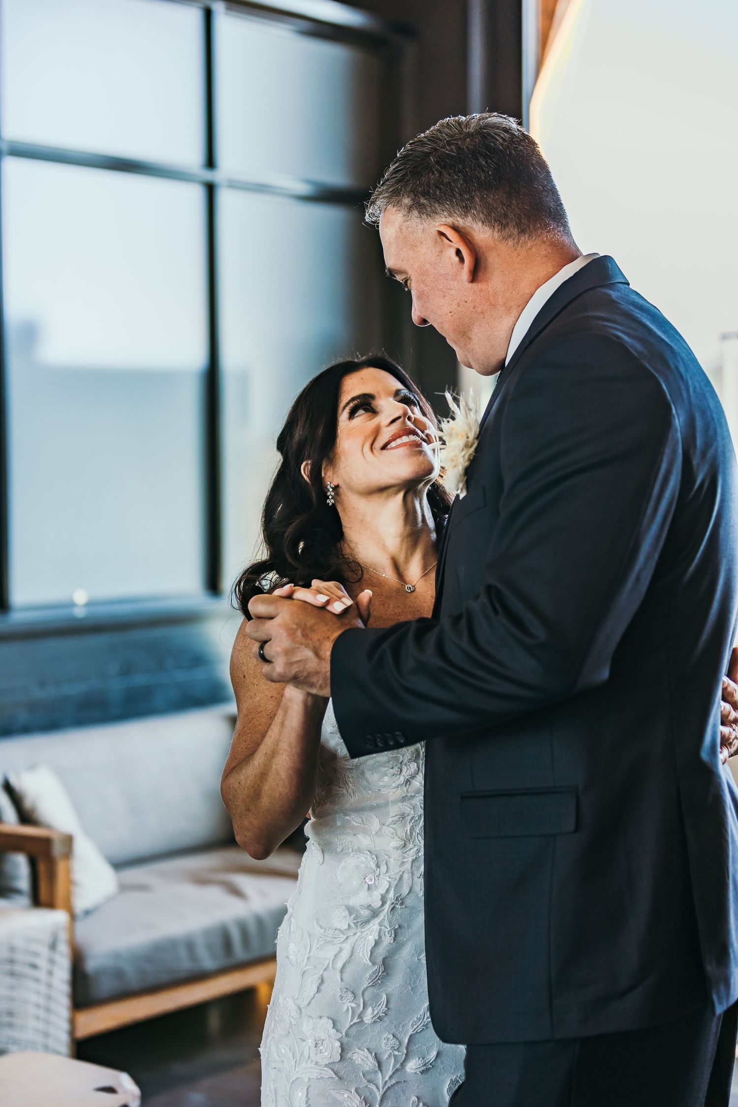 Joyful moment shared between couple during wedding celebration indoors.