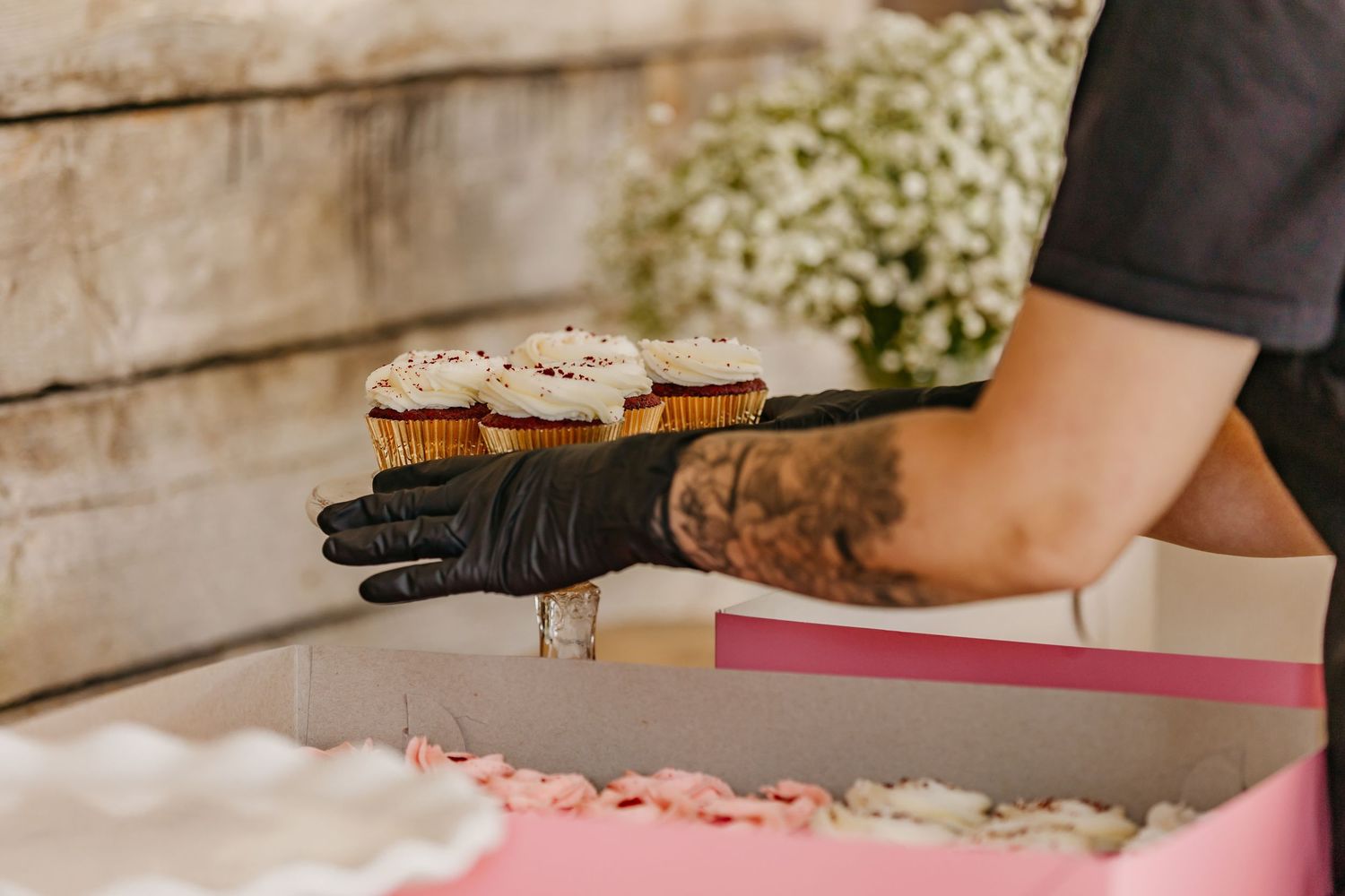 Event preparation showing hands arranging decorative elements on tables.