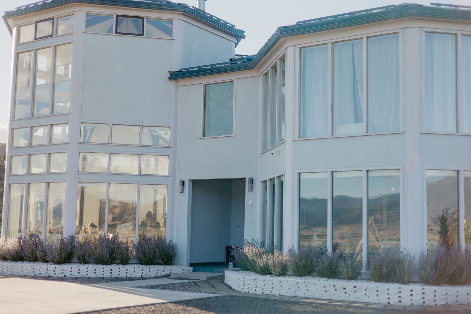 Modern coastal wedding venue with large windows and ocean views.
