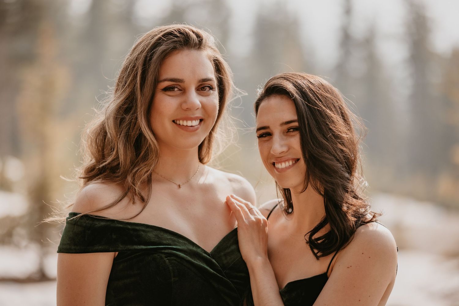 Two people share a joyful moment together outdoors with natural lighting.