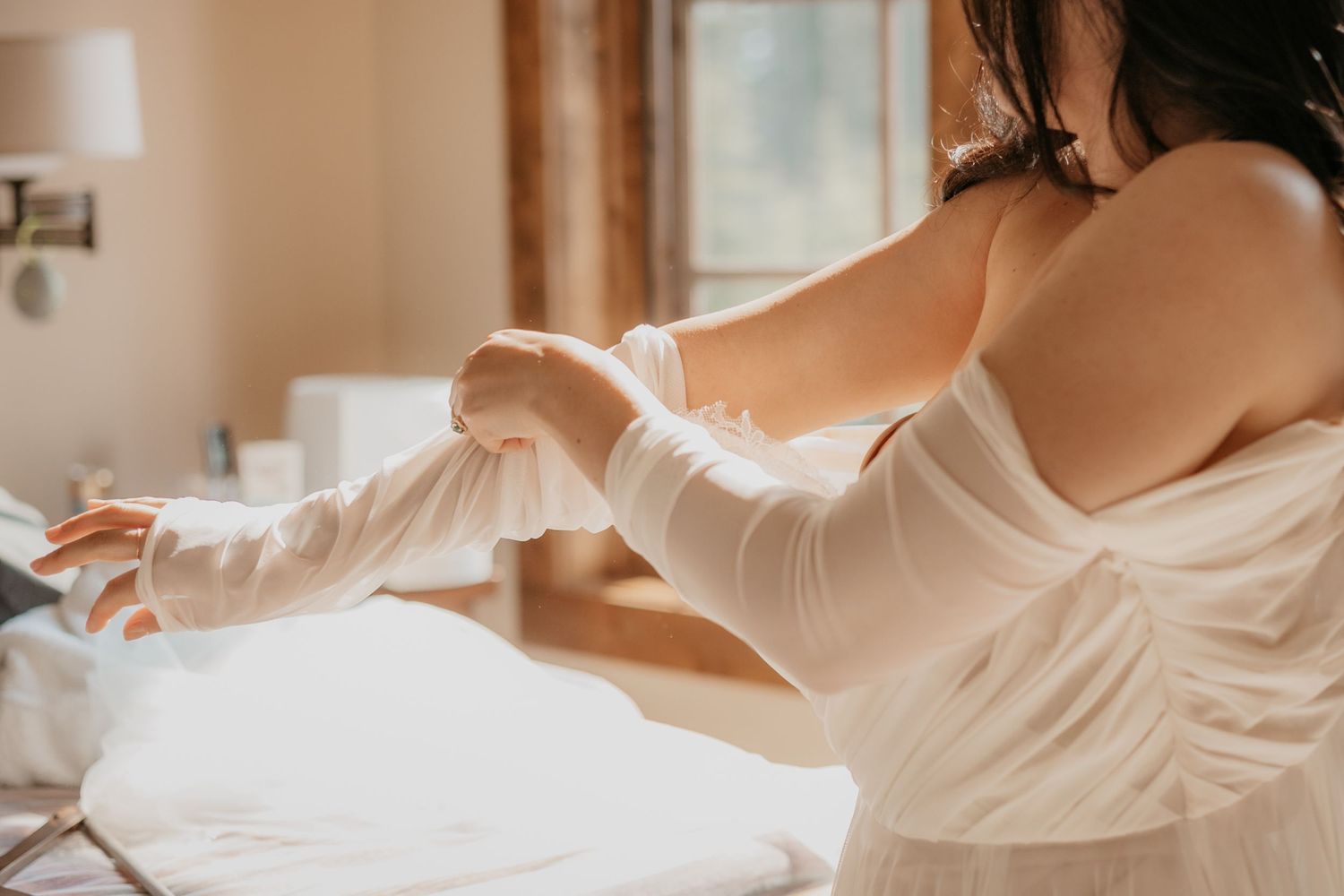 Ethereal bridal preparation photos showing flowing fabric in morning light.