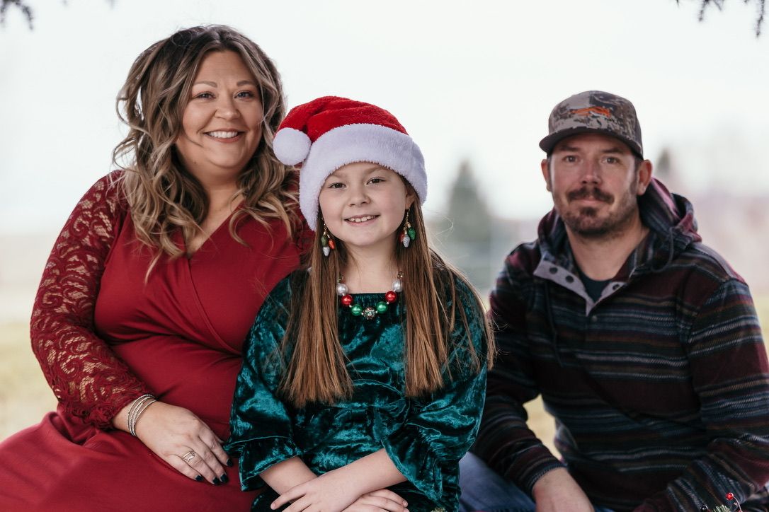 Holiday family portraits with festive red and green outfits.