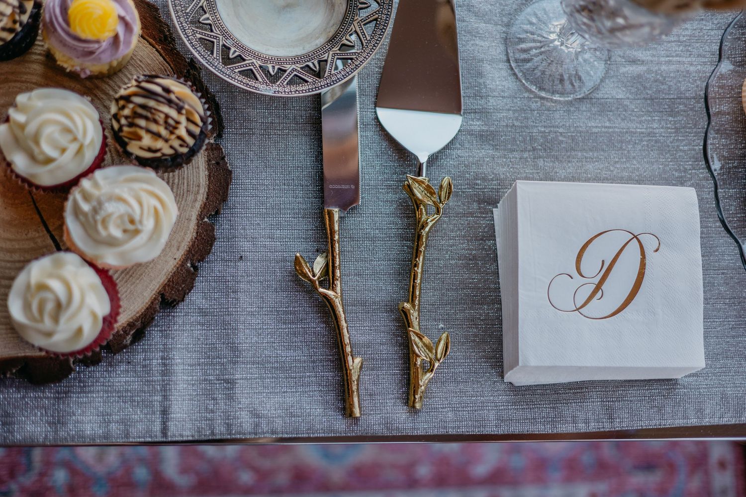 Wedding reception table details with monogrammed napkins and decorative elements.