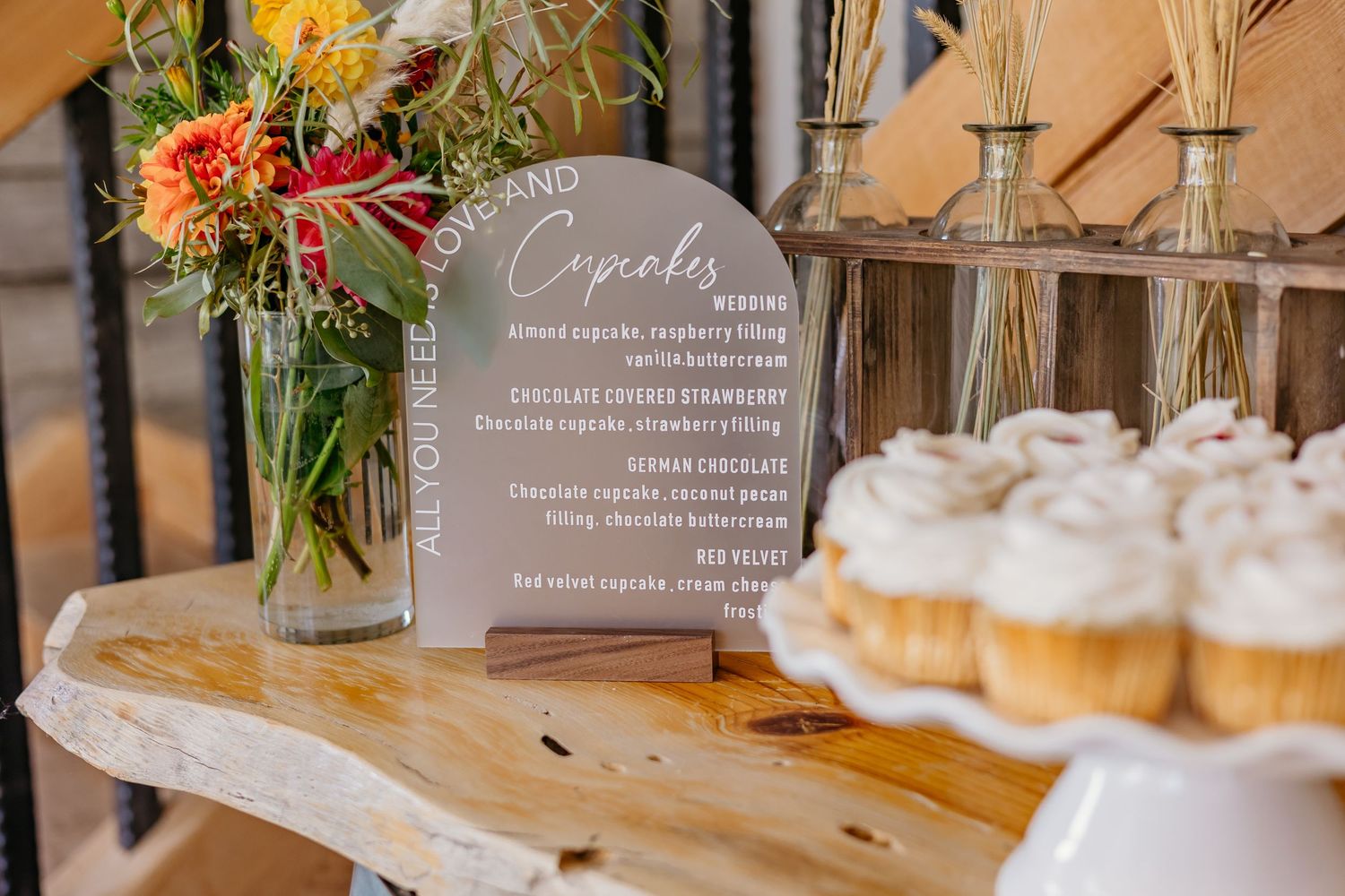 Elegant table settings with floral centerpieces and menu cards at a rustic wedding reception.