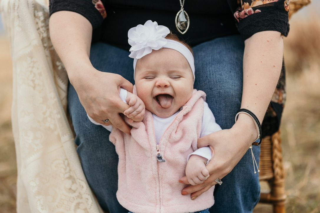 Sweet moment captured in outdoor family photoshoot with natural lighting.