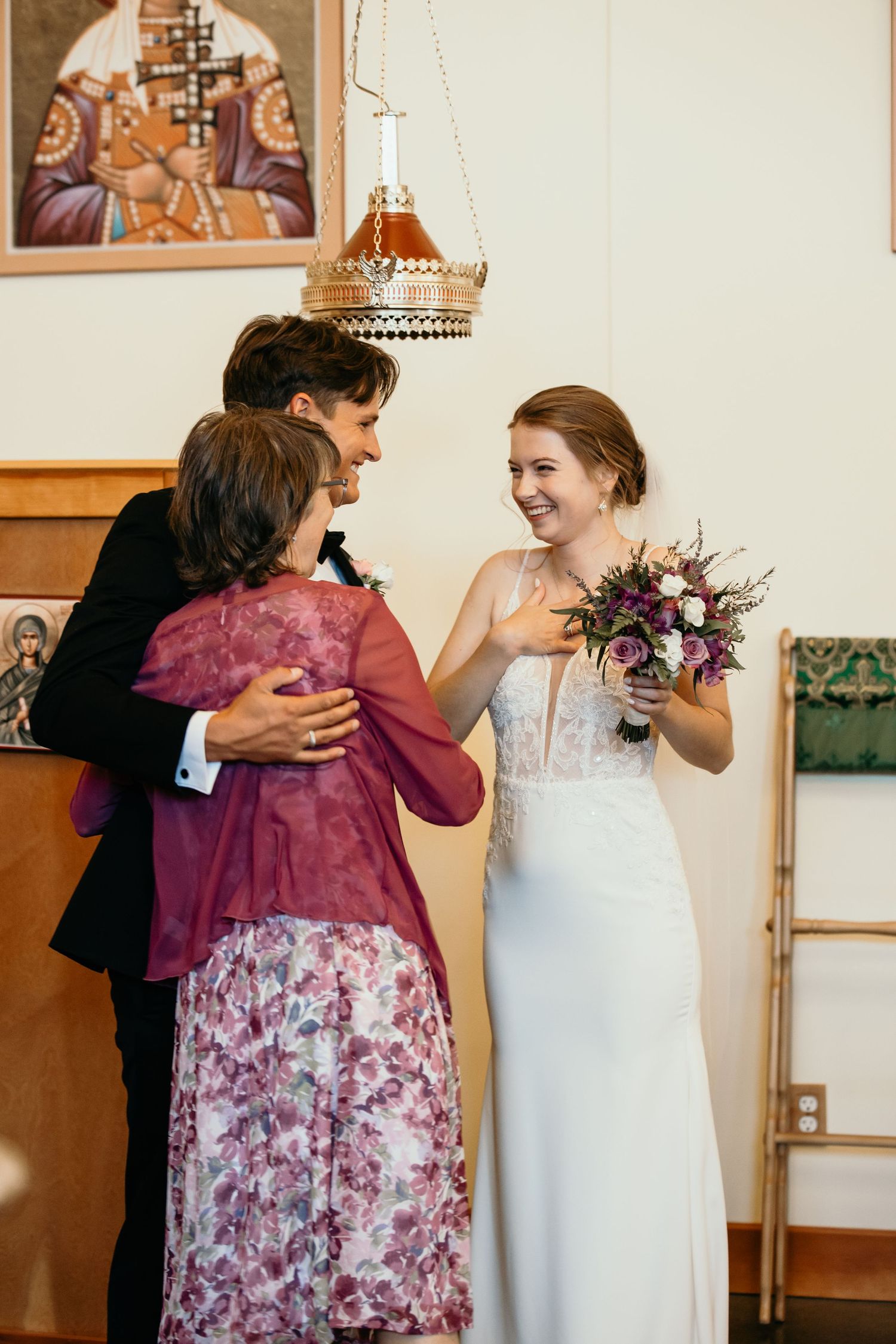 Wedding celebration in church with decorative icons and warm lighting.