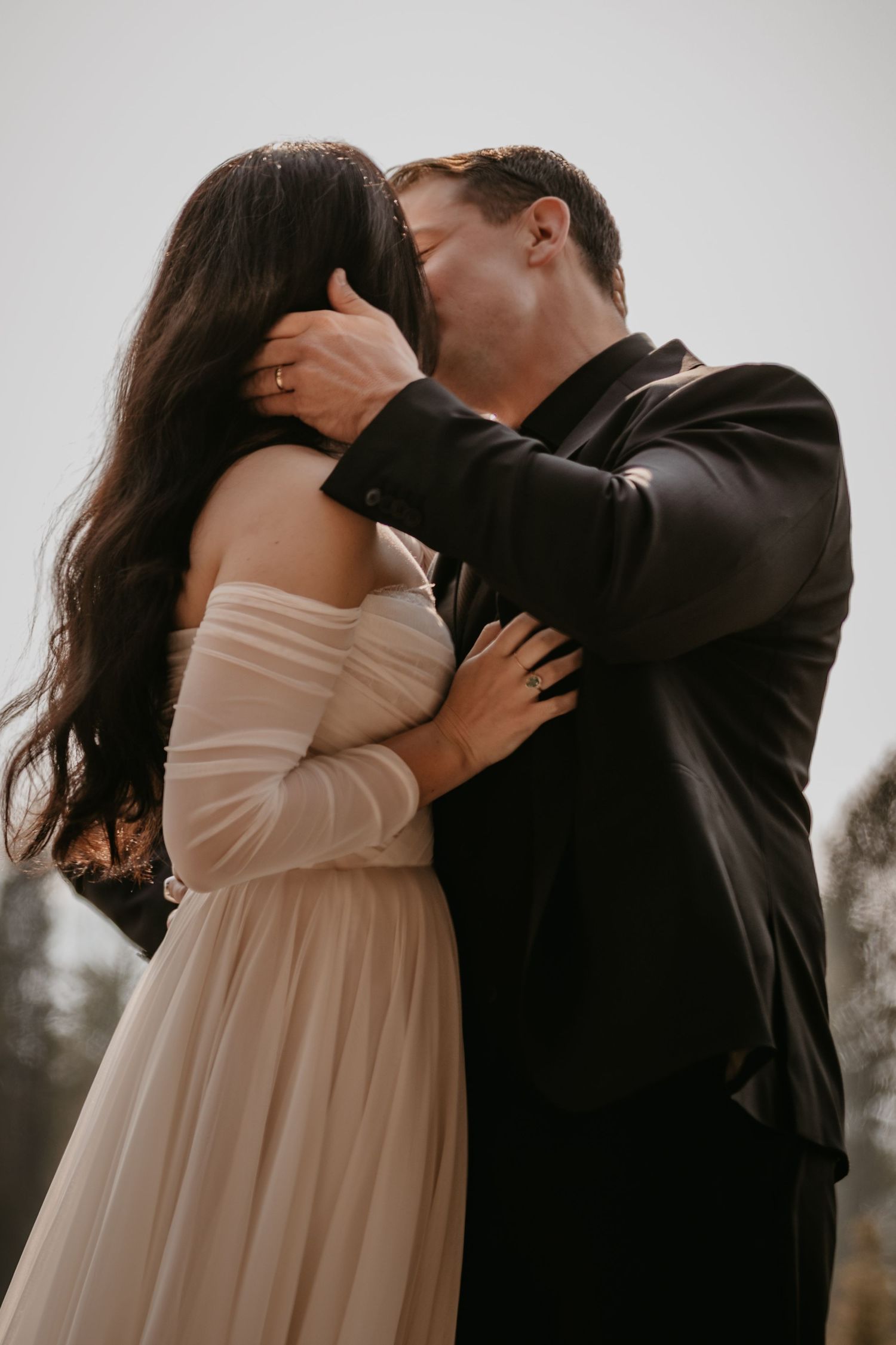 A tender moment between newlyweds during their intimate mountain wedding ceremony.