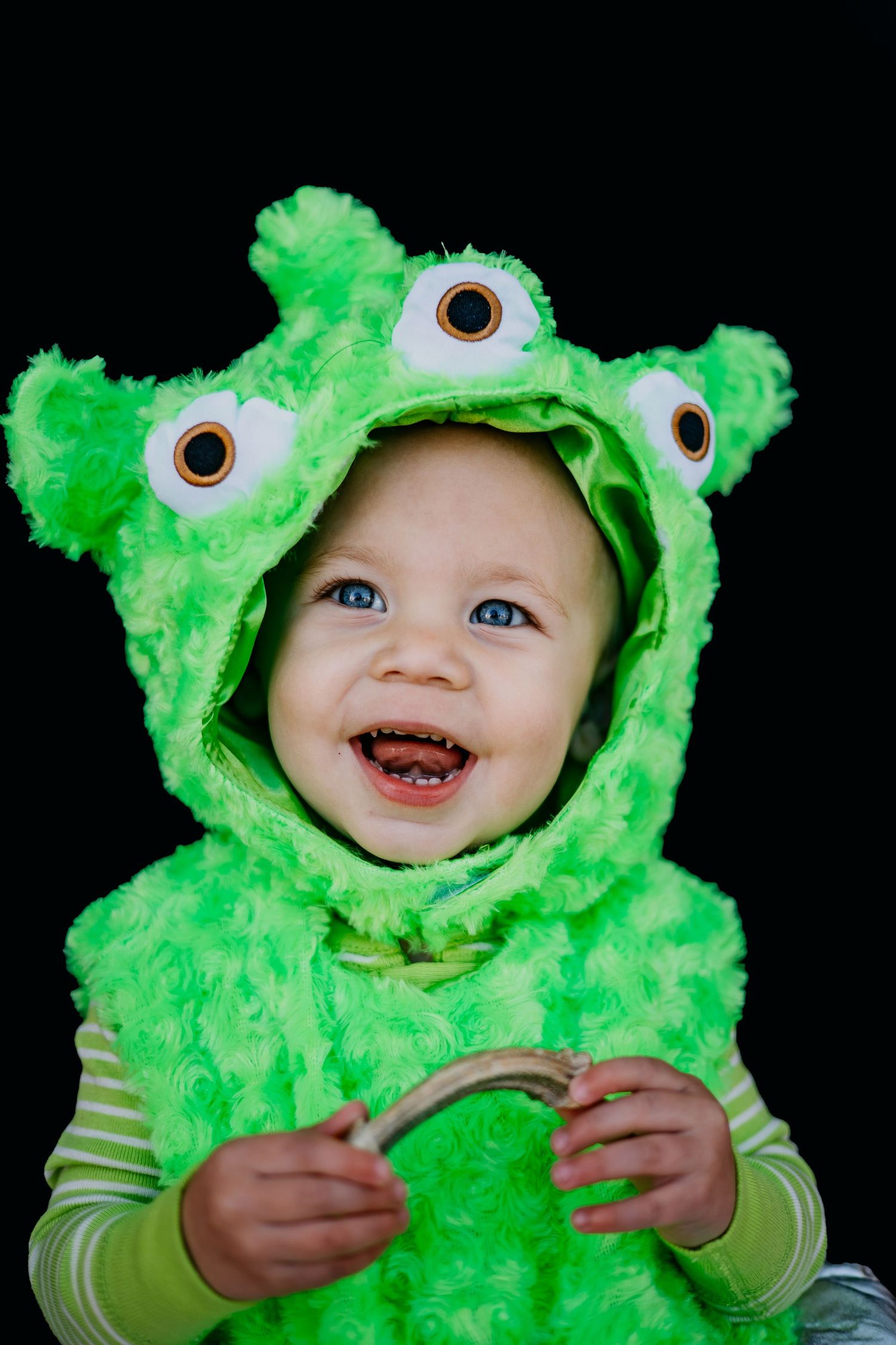 Bright green monster costume with fuzzy texture and googly eyes.