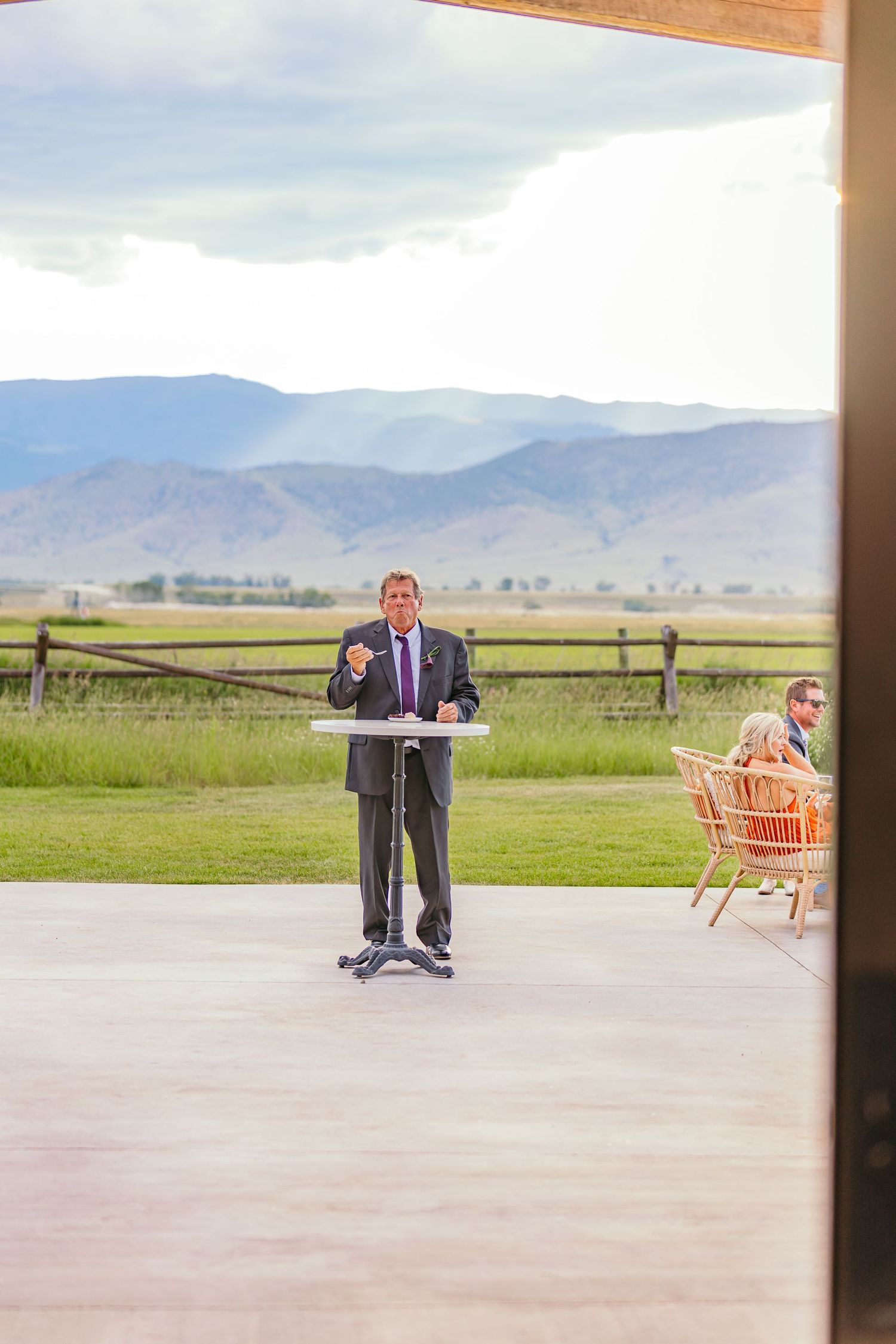 Outdoor wedding ceremony setup with mountain landscape in the background.