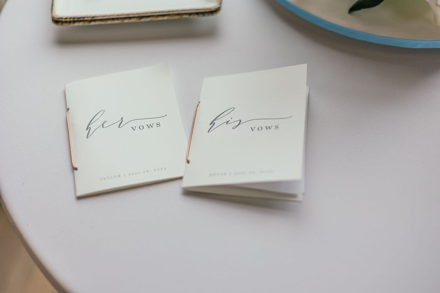 Close-up view of handwritten wedding cards on a light surface.