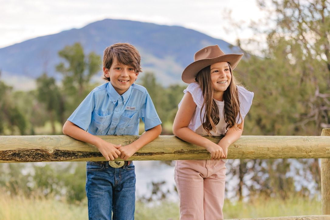 Candid outdoor portraits taken in a field with mountains in the background.