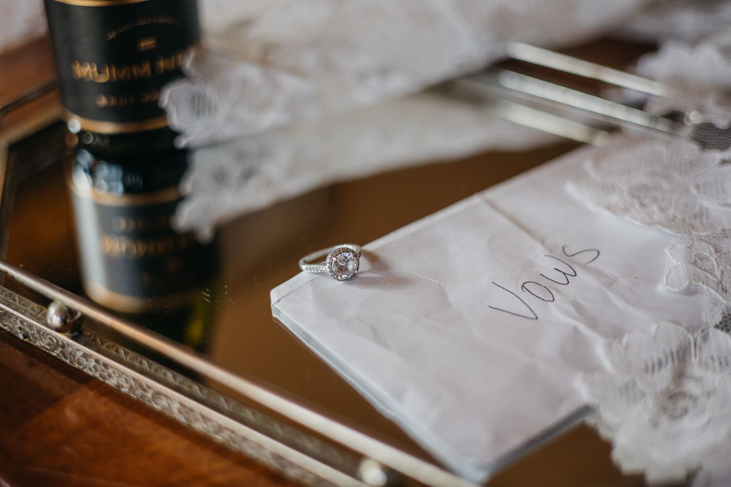 Elegant wedding table settings with white tablecloths and vintage plates at a rustic venue.