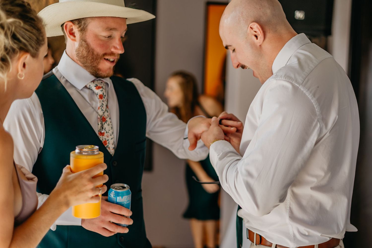 Wedding guests mingle and enjoy drinks during an outdoor reception celebration.