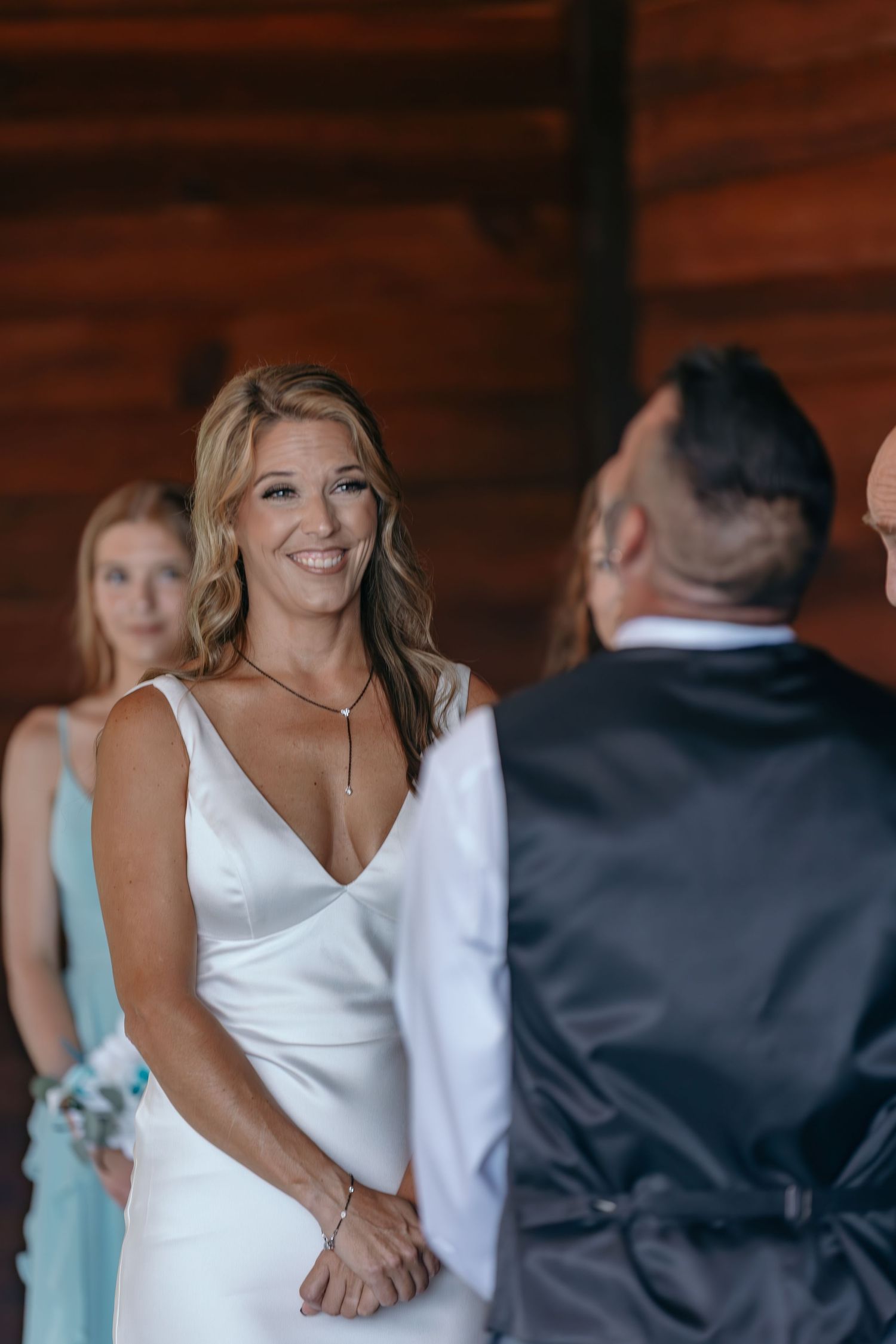 Wedding guests share joyful moments and laughter during an indoor celebration.