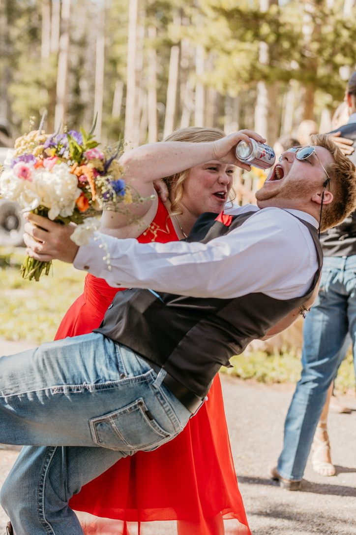 Wedding guests performing choreographed dance moves in outdoor setting.