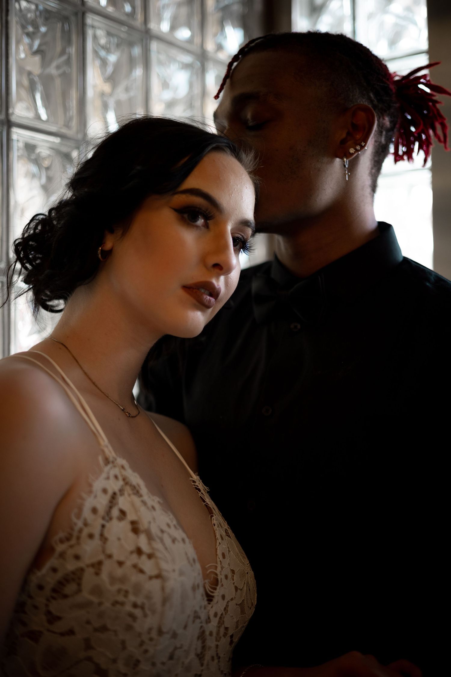 Intimate indoor portrait series with dramatic window lighting.