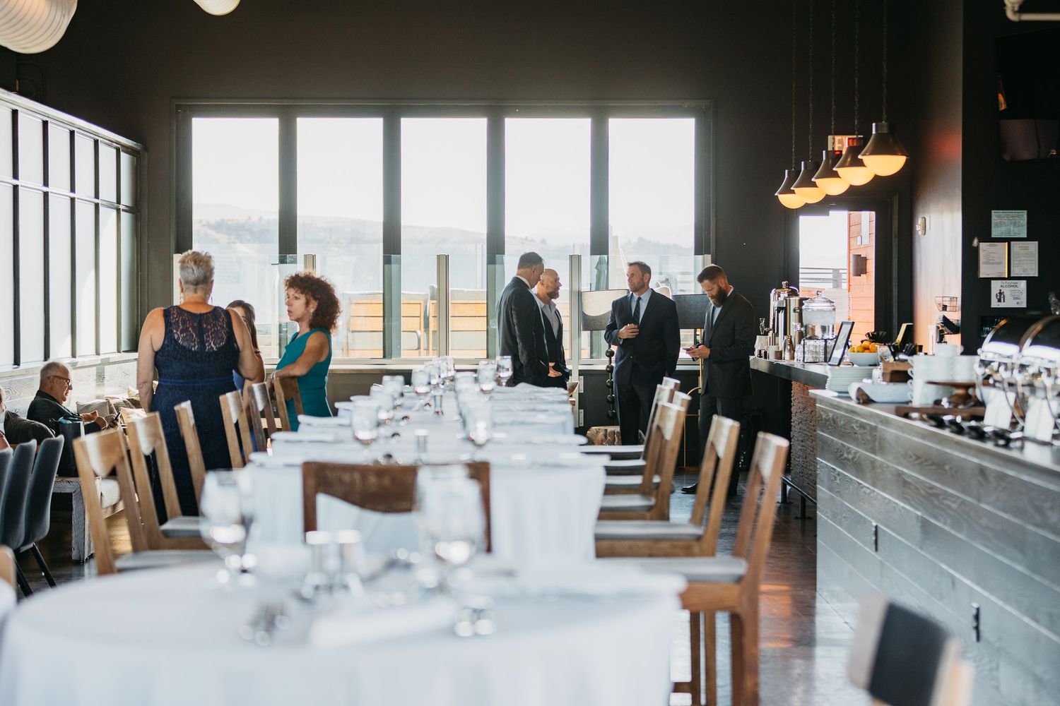 Modern wedding reception venue with floor-to-ceiling windows and minimalist decor.