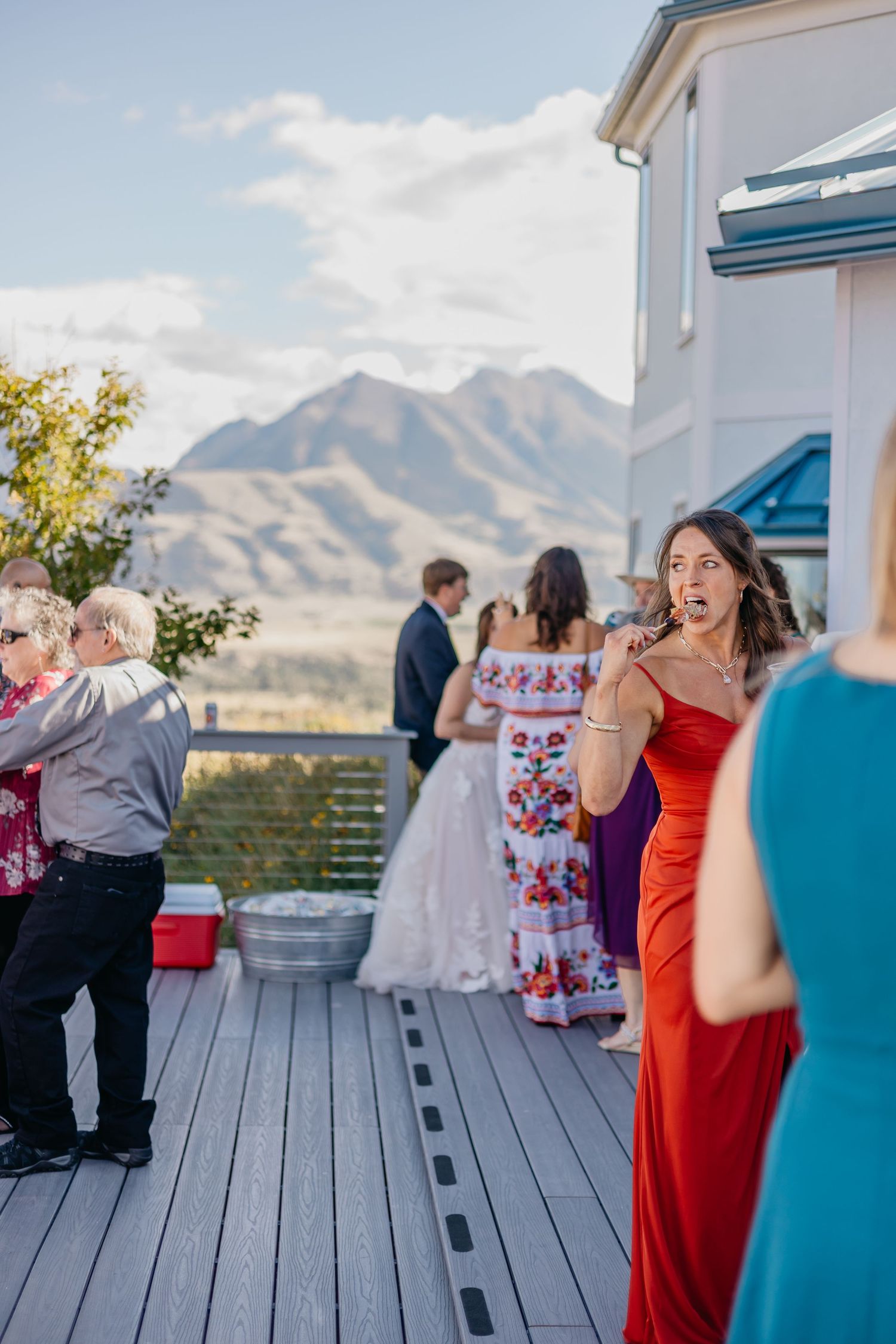 Wedding reception on mountain deck with stunning mountain vista in background.