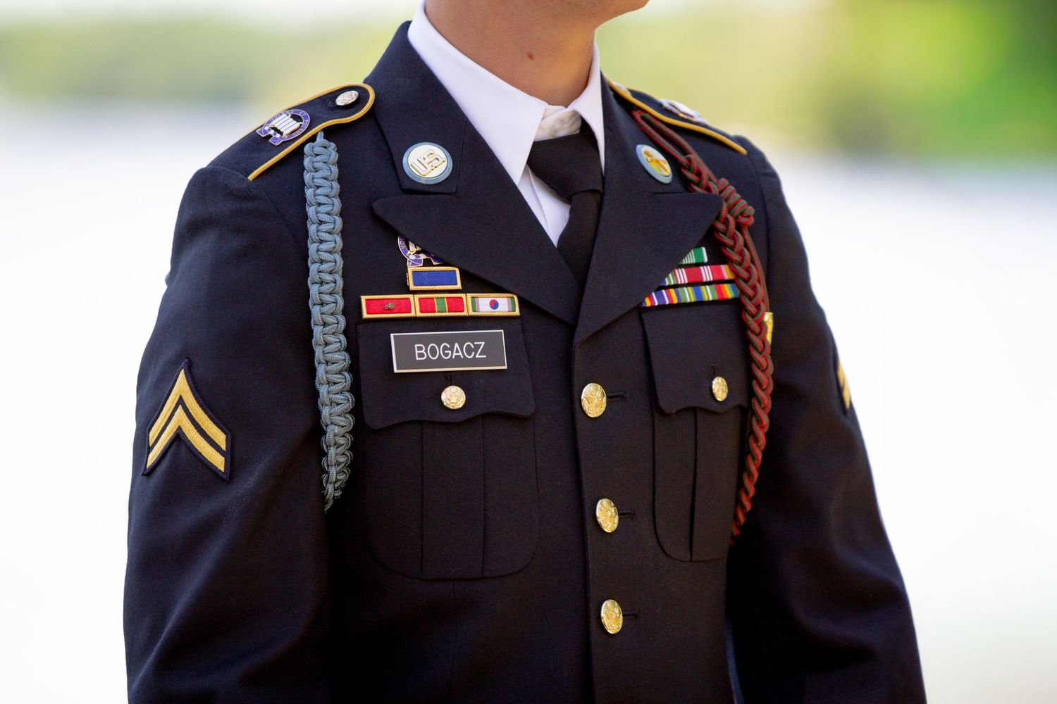 Military dress uniform with medals, ribbons and decorative cord.