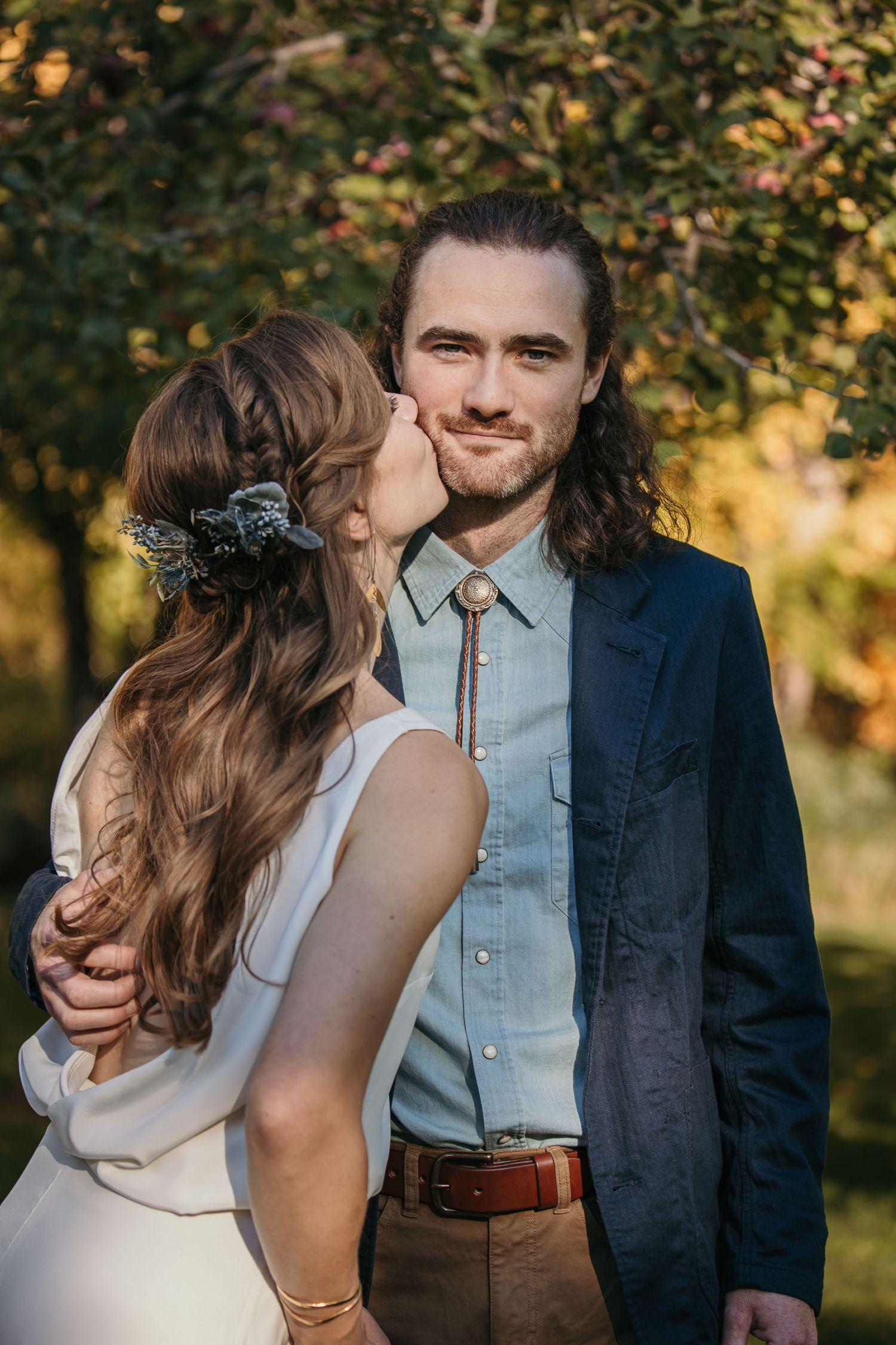 Intimate outdoor portrait series showing tender moments between a couple against fall foliage.