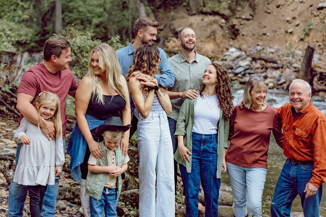 Group laughing together during a casual outdoor photo session.