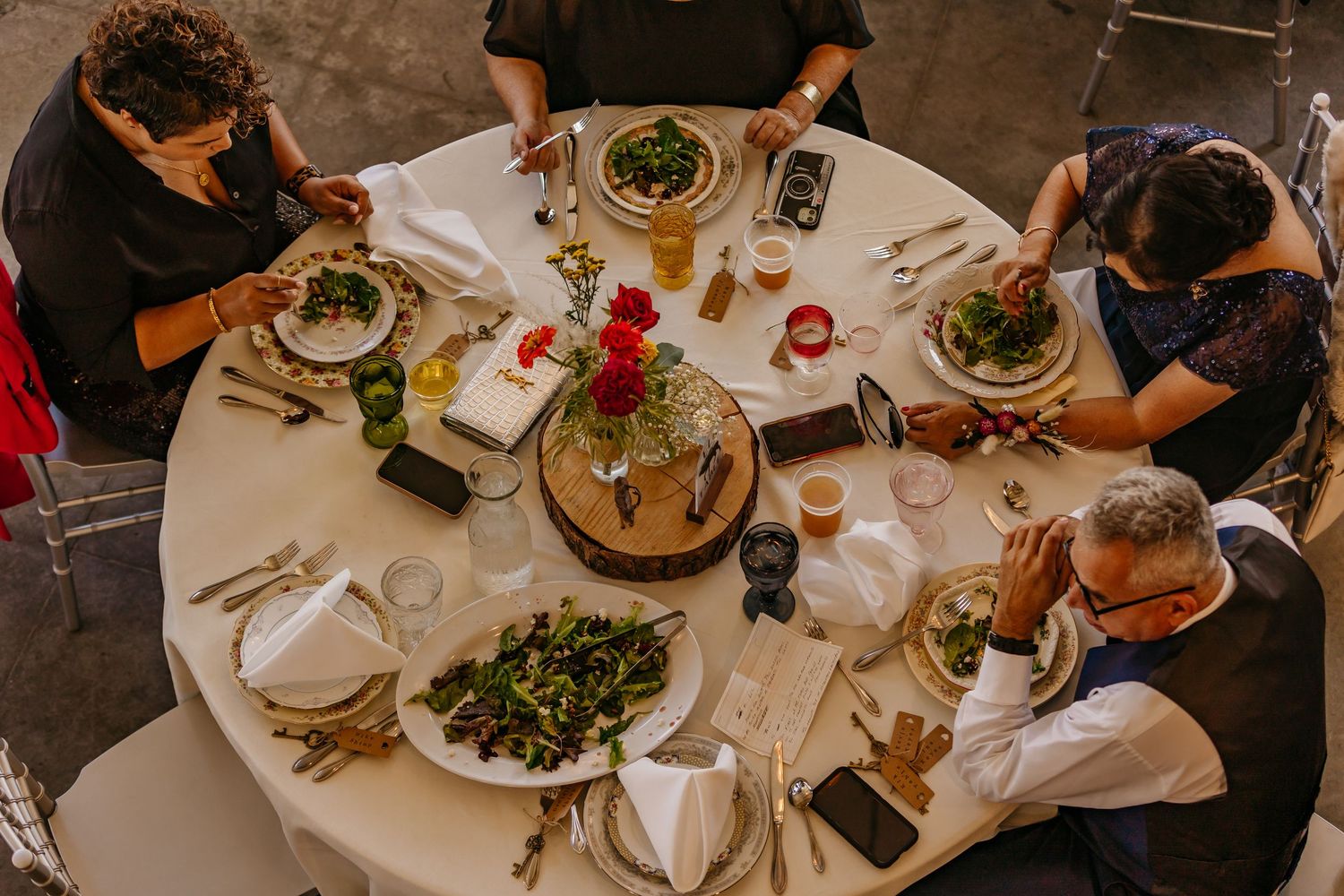 Overhead view of wedding reception dinner tables with elegant place settings.