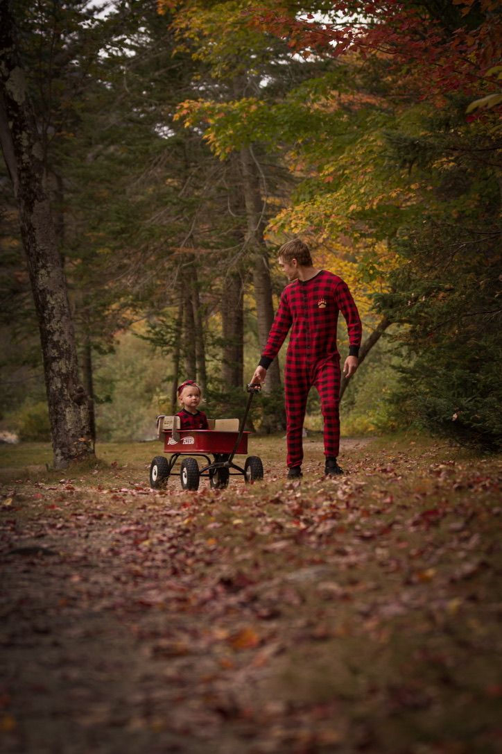 Autumn forest walk in red plaid flannel among fallen leaves.