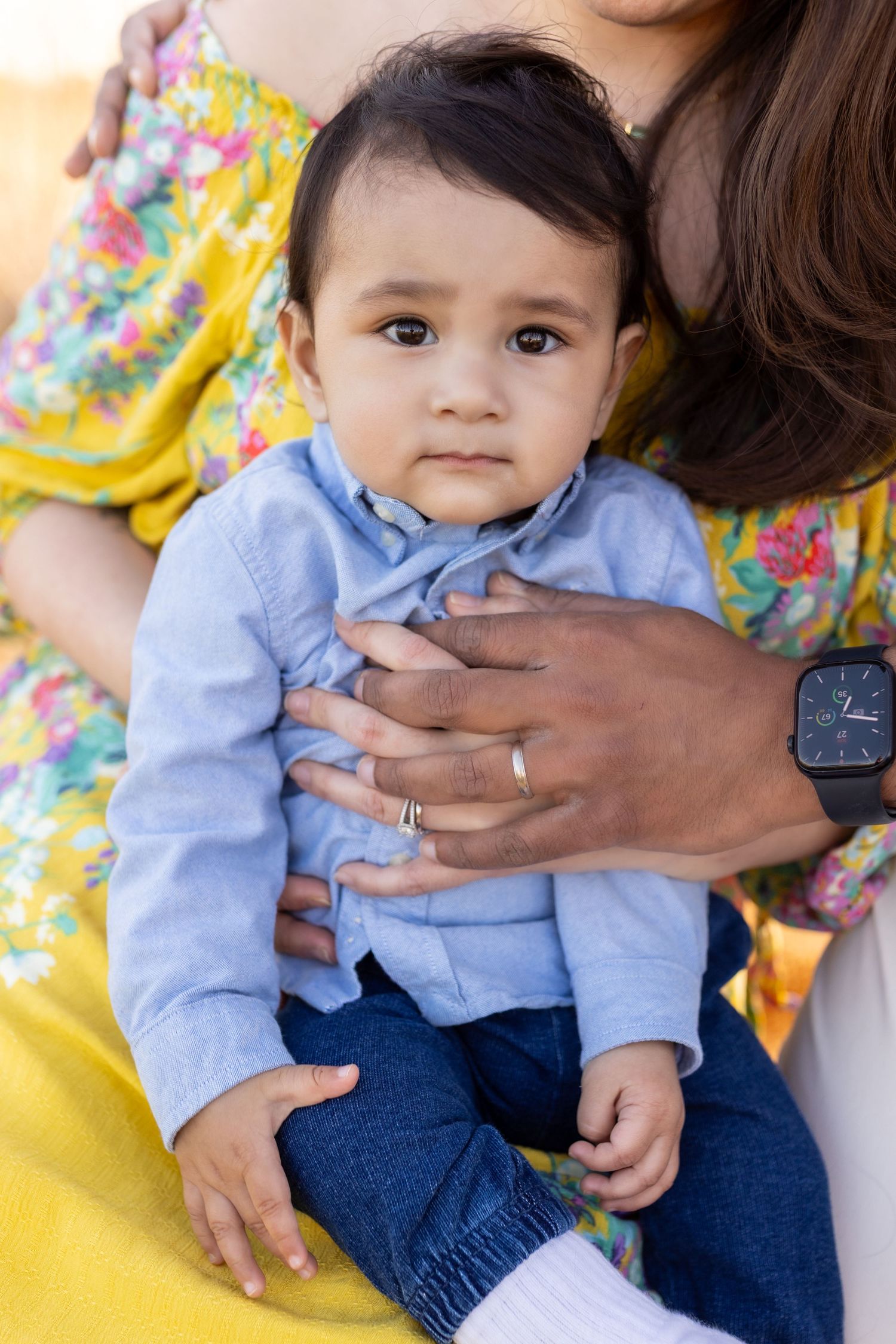 Close-up shots of family outdoors with yellow floral dress and blue shirt details.