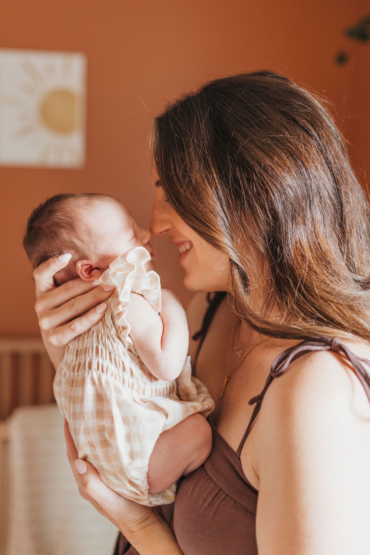 Close-up sequence of intimate family moments in a warm-toned room.