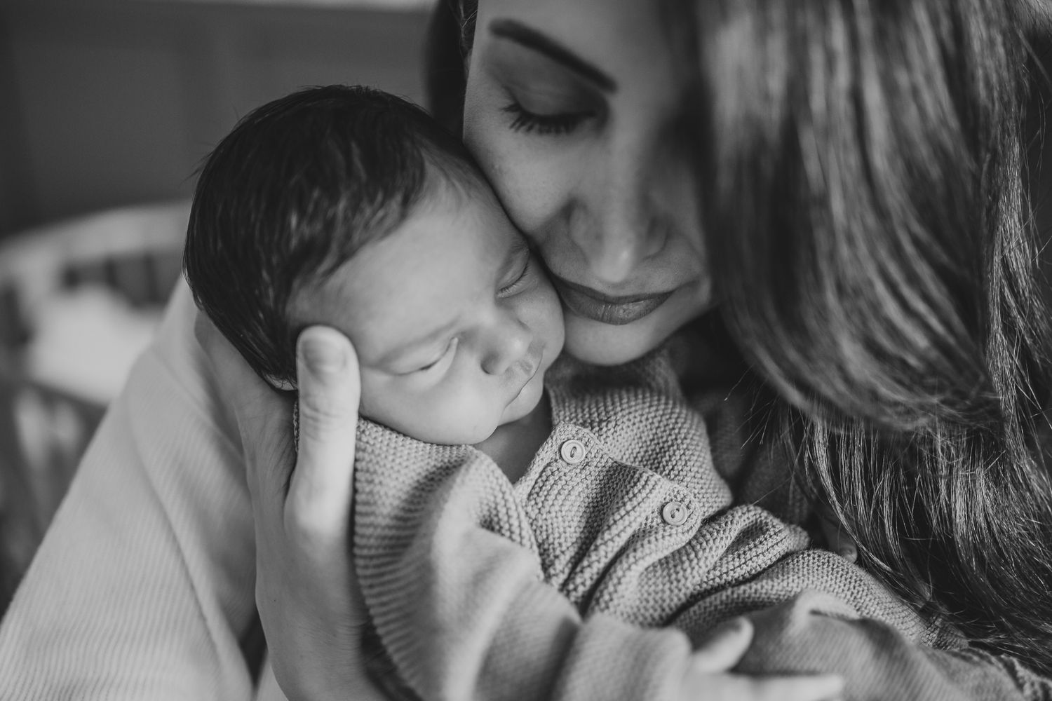 A series of intimate black and white photographs showing tender moments between mother and baby