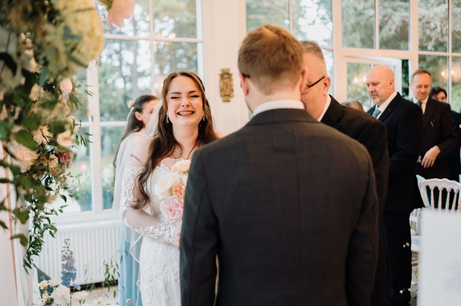 Joyful bride laughs as she meets groom at the altar during an intimate wedding ceremony.