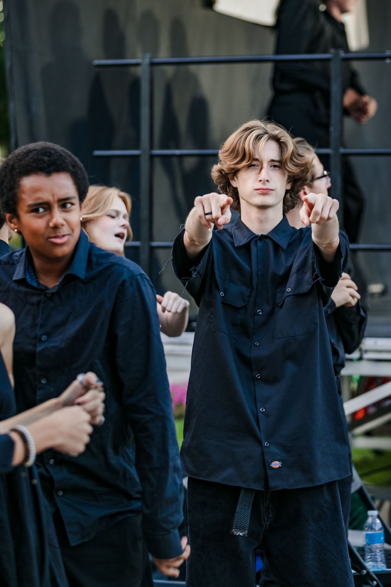 Performers on stage in black outfits during a live outdoor block party event in Northern Colorado