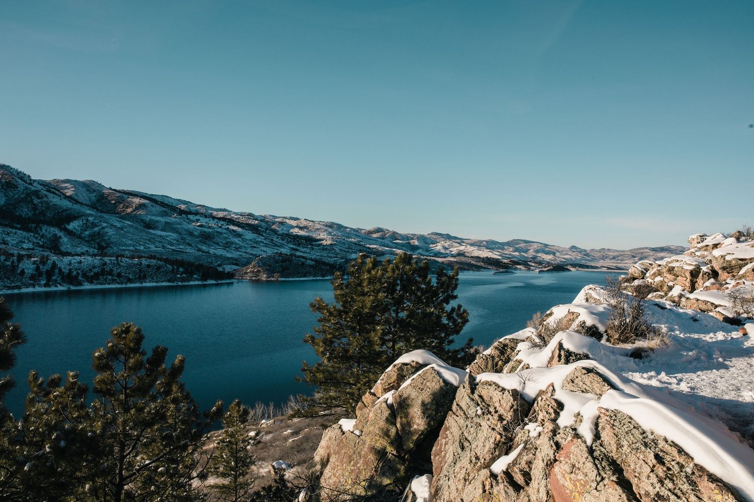 Scenic view of snowy Horsetooth Reservoir and surrounding mountains in Fort Collins, Northern Colorado