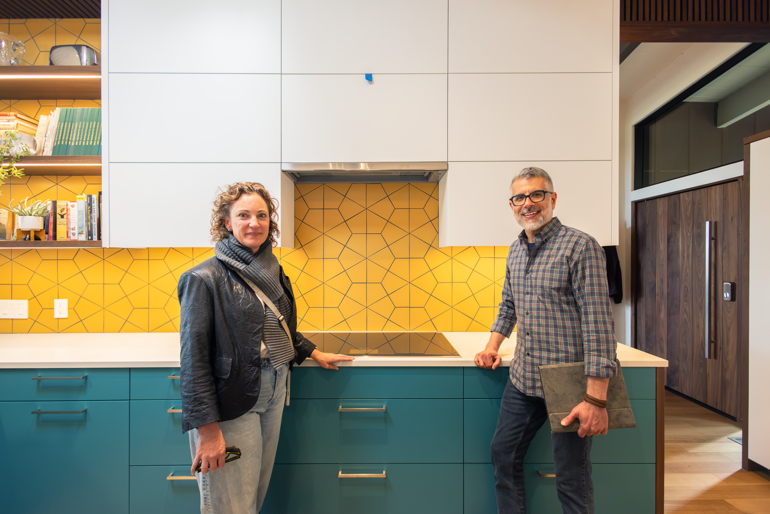 Photo of two individuals, small business owners and architects based in Berkeley, California, in a completed kitchen they designed.