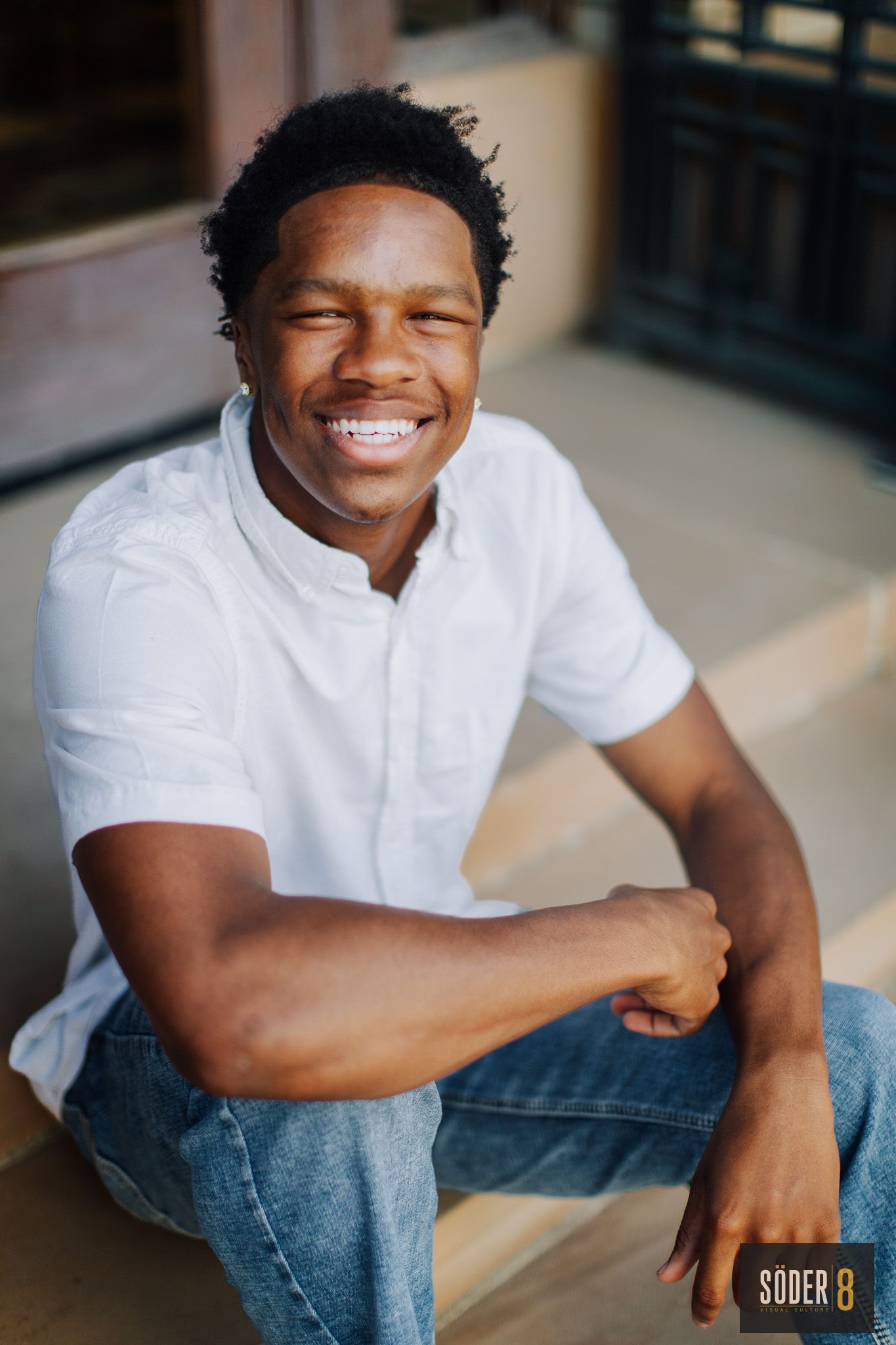 young man smiling in high school senior portrait