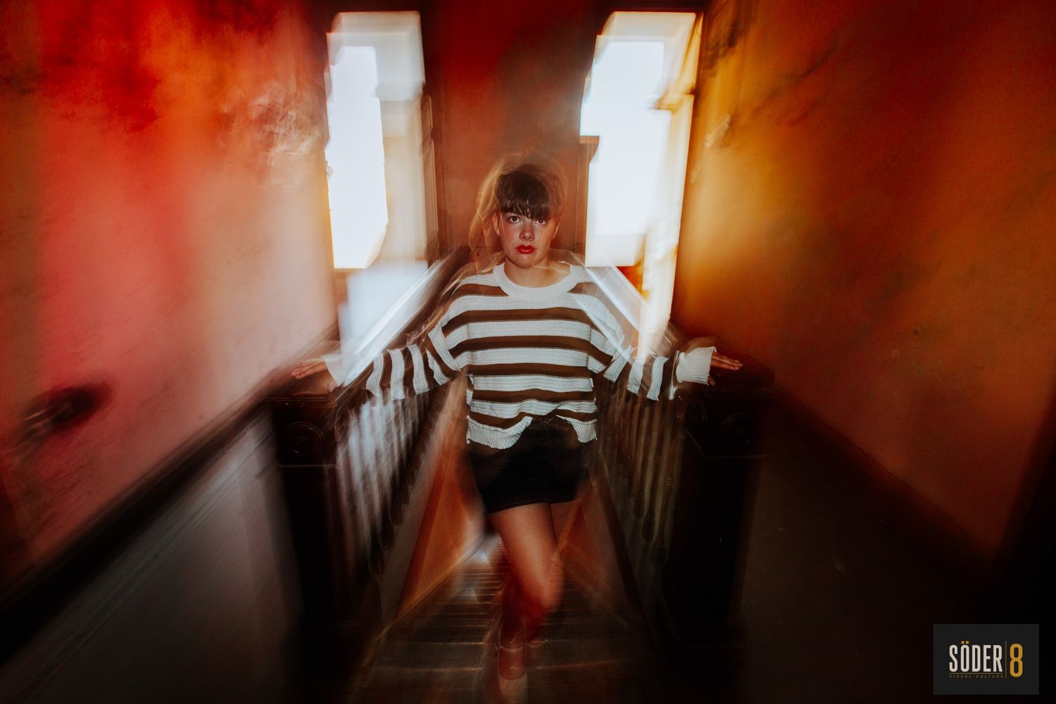 high school senior girl standing on steps with colorful motion blur all around her in charles city, iowa - SODER 8