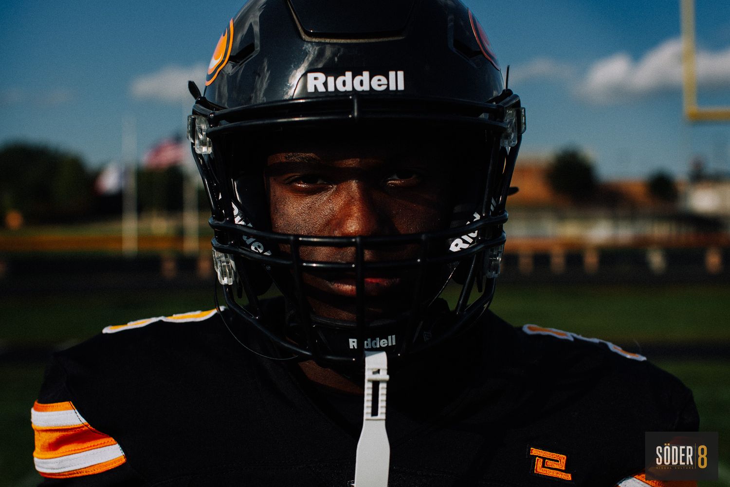 high school senior photo of boy in charles city comets football helmet in charles city, iowa - SODER 8