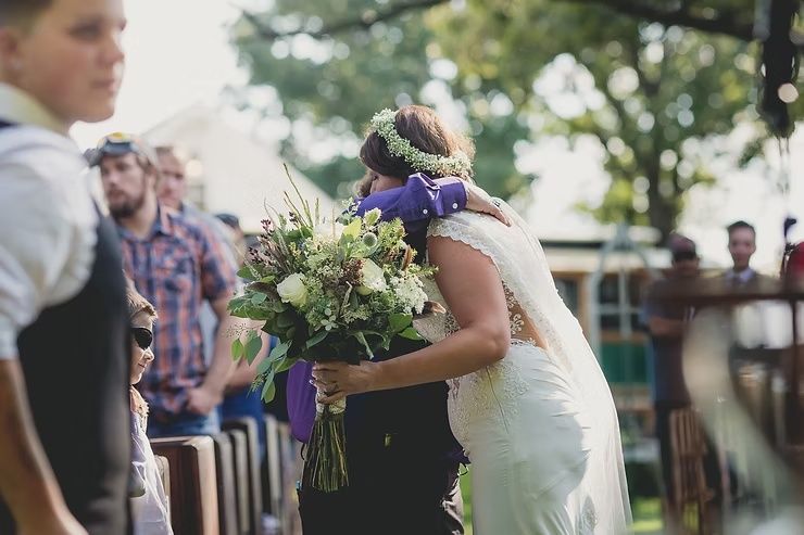 bride hugging mom during wedding ceremony