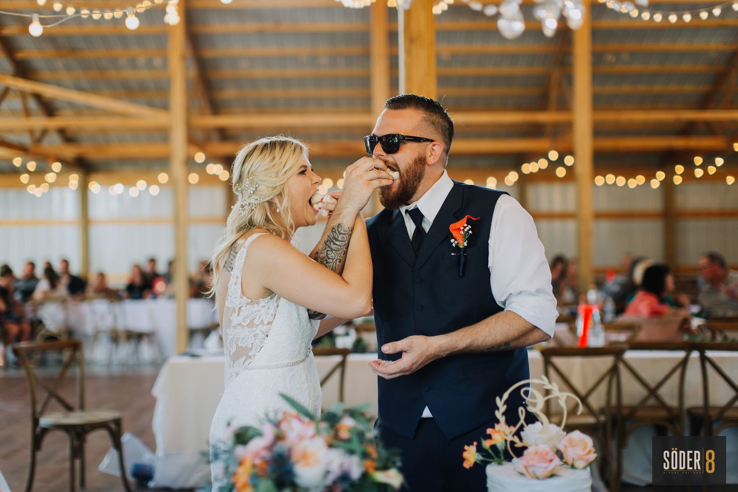 bride and groom sharing cake at wedding reception