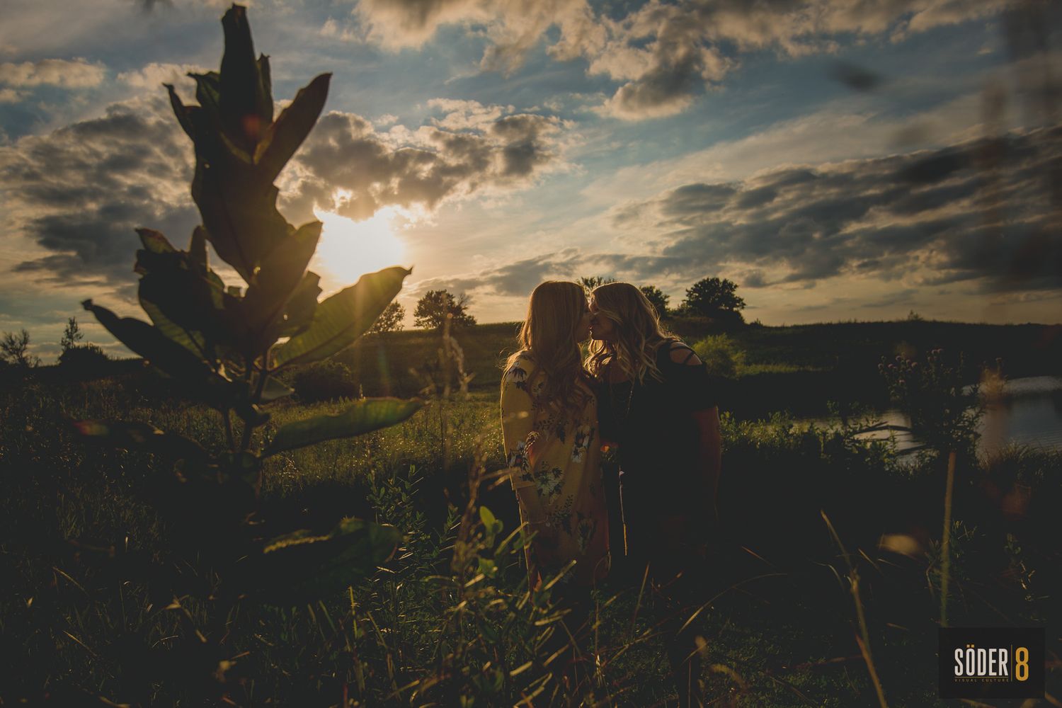 same sex couple on Iowa prairie for engagement photo