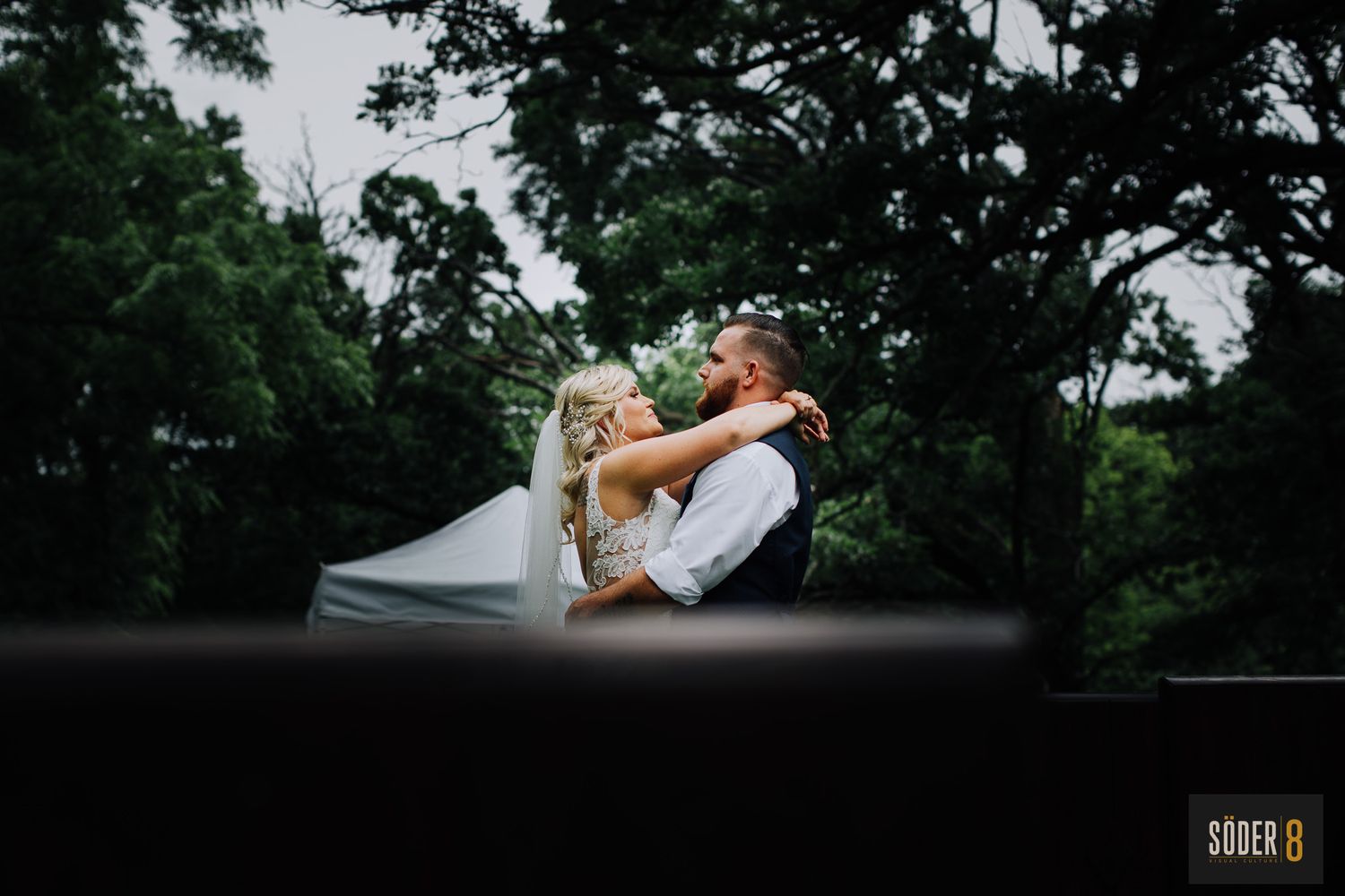 Bride and groom hugging at outdoor wedding
