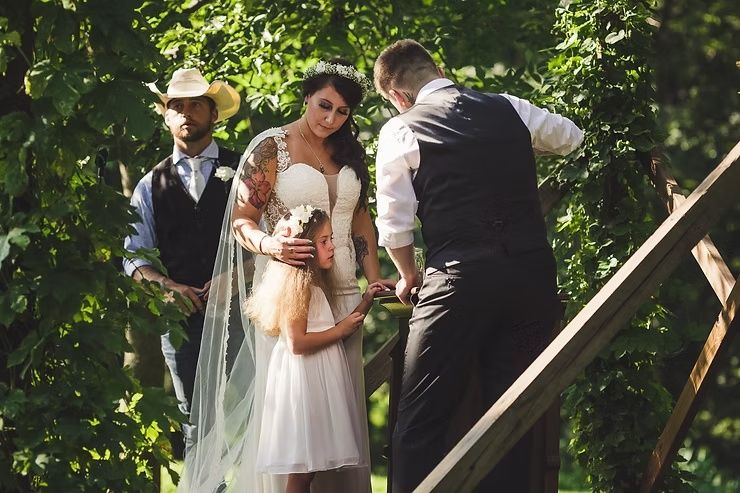 same-sex wedding couple and daughter at outdoor iowa wedding