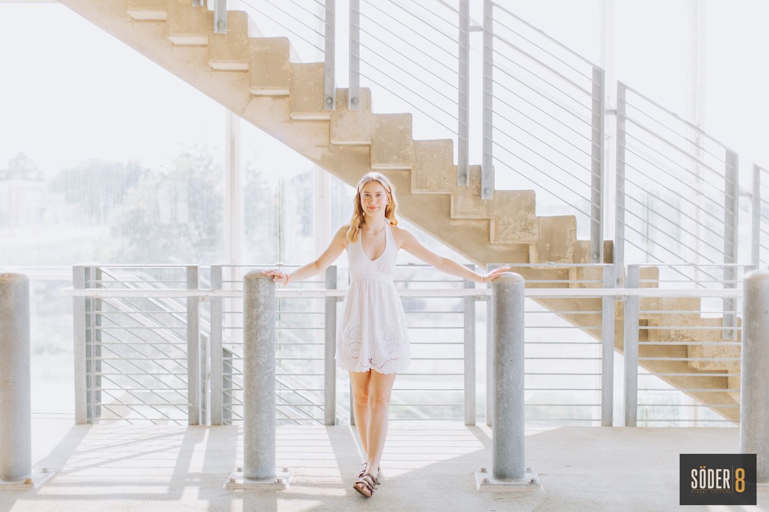 girl standing by parking garage stairs