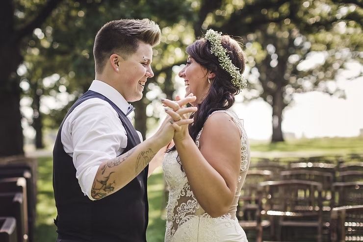 same sex wedding couple smiling at each other during first look