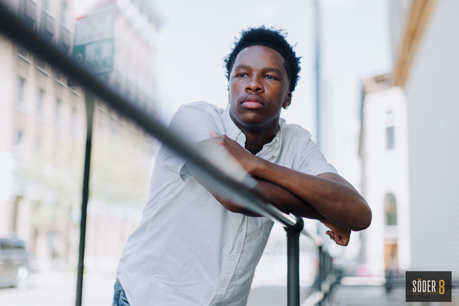 young man leaning on railing