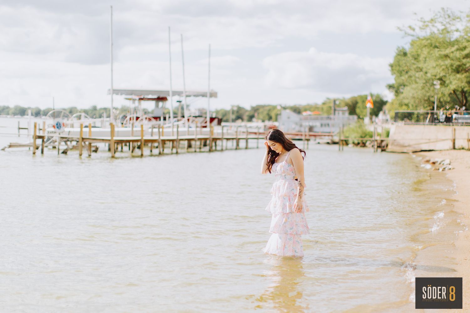 senior portrait of girl walking in clear lake