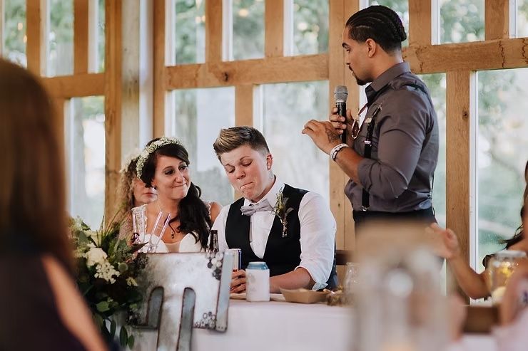 lgbtq groom crying during best man speech at iowa barn wedding