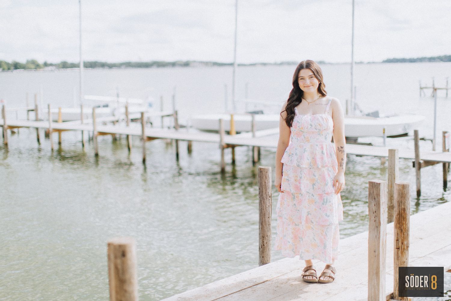 high school girl standing pier on clear lake